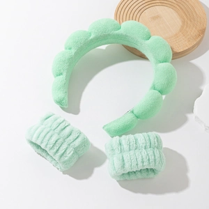 Detailed view of mint green cloud headband and wristband set for skincare routines