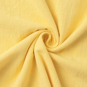 Detailed macro view of breathable light yellow cotton linen fabric with soft fiber texture