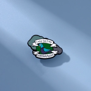Funny pigeon enamel pin with 'I will shit on everything you love' text on green background