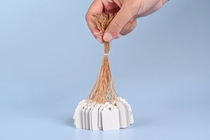 Detail showing a bunch of white blank jewelry price tags with brown string on blue background
