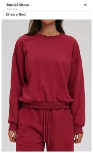 Detail of soft cherry red long sleeve crewneck sweatshirt set with matching drawstring pants