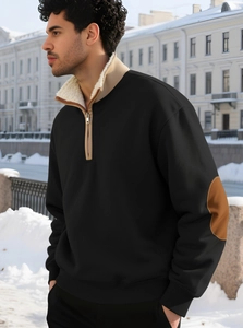 Close-up of black quarter-zip sweatshirt featuring sheepskin lining and leather elbow patches