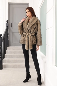 Detail of tan faux fur coat featuring a plush texture, large lapels, and matching belt