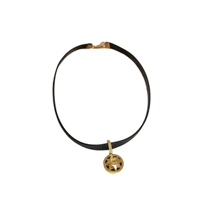 Dark style star charm choker featuring black faux leather and a gold oval pendant