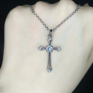 Silver cross pendant necklace with clear center stone on delicate chain for unisex style