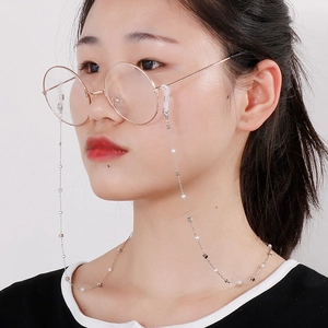 Elegant pearl and chain eyewear strap worn by model on white background