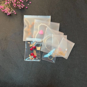 Moisture-proof EVA clear sealer bags for jewelry storage in various sizes on a dark desk