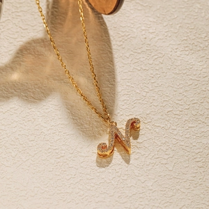 Macro view of 18K gold plated O-chain necklace with sparkling zircon pavé letter N pendant