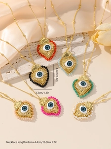Macro shot showing evil eye heart necklace dimensions 4.5x3.3cm on silk and stone base