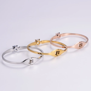 Polished titanium steel bangles in silver, gold, and rose gold with sparkling cubic zirconia