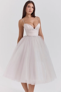 Close-up of pink tulle mesh dress with halter neckline and high-waist bow detail