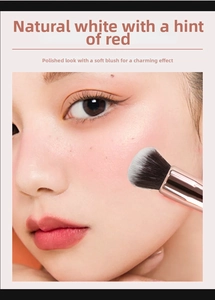 Macro view of a soft makeup brush applying liquid foundation to a model's cheek skin