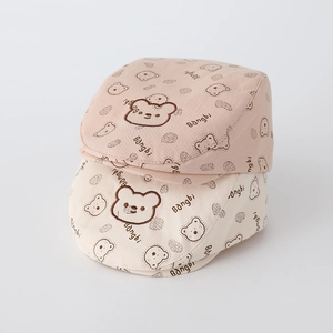 Close-up of baby berets featuring cute bear embroidery and printed breathable cotton fabric