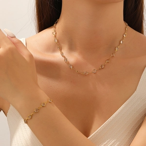 Gold plated stainless steel necklace and bracelet set with clear crystal accents