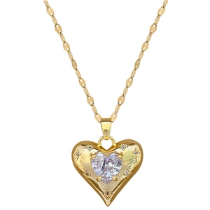 Elegant gold titanium heart necklace with centered crystal and pavé accents on white background