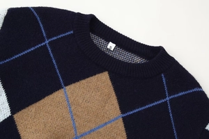 Detail of navy diamond-pattern knit sweater neckline with S-size label on white background