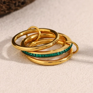 Detail of 18K gold plated triple-layered stainless steel ring with green emerald-cut stone