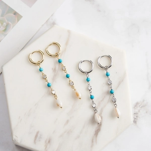 S925 silver hoop earrings with turquoise tassels and white shell drops on marble stand