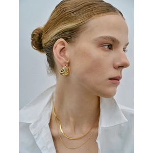 Detail of 18k gold teardrop earrings with crystals and double layer snake chain necklace