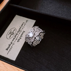 Detail of silver-plated lattice hollow ring featuring a large sparkling center zircon