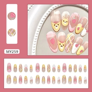 Sweet pink press-on nails featuring cute strawberry, cartoon bear, and grid patterns