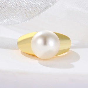 Minimalist wide gold band ring featuring a single large white pearl in a luxury style