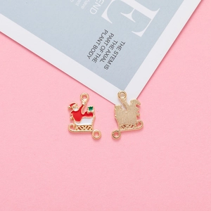 Detailed macro view of gold-plated Santa Claus sleigh pendant with enamel details