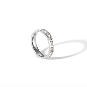 Macro shot of silver titanium steel eternity ring with channel-set zircon crystals