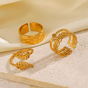 Set of three vintage gold adjustable stainless steel rings with leaf and star patterns