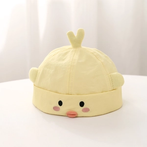 Close-up of baby yellow duck hat featuring 3D orange beak and soft cotton texture