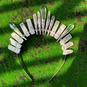 Close-up of handmade crown headband with natural clear crystal quartz on green moss