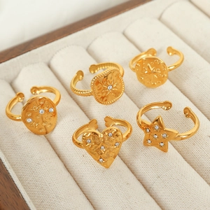Five-piece set of gold plated titanium steel rings with crystals in a beige display box