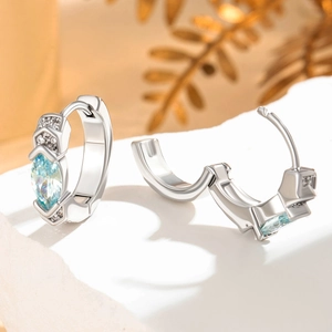 Boucles d'oreilles créoles argentées en zircon bleu clair marquise sur socle en marbre