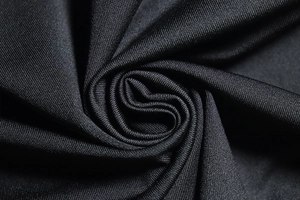 Close-up of black knitted fabric texture showing fine weave and high elasticity detail