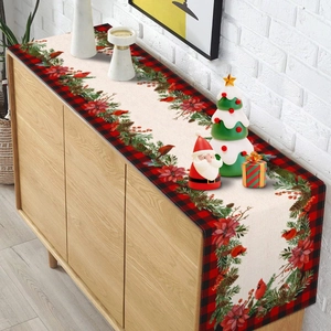 Close-up of Christmas table runner with red bird, pine needles, and plaid borders
