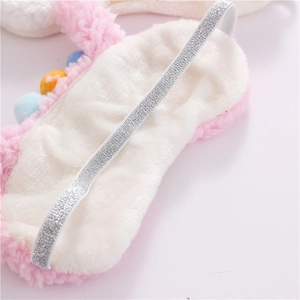 Detail of soft pink plush sleep mask with silver glittery elastic adjustable strap