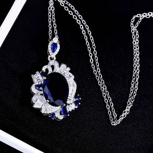 Royal blue sapphire necklace set with oval pendant in a premium black velvet jewelry box