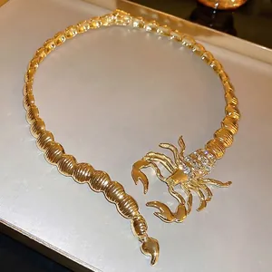 Exaggerated gold scorpion choker necklace with rhinestones in an open collar design