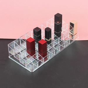 Detailed view of a multi-slot clear acrylic lipstick organizer showing various lip glosses