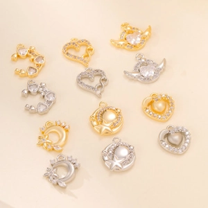 Detailed view of gold and silver celestial moon, star, and heart charms with zircon inlay