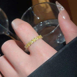 Close-up of 18k gold plated ring featuring rectangular cut yellow zircon stones