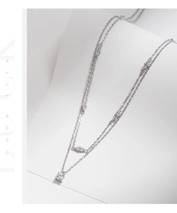 Macro shot of double-layered silver necklace with sparkling D-color moissanite accents