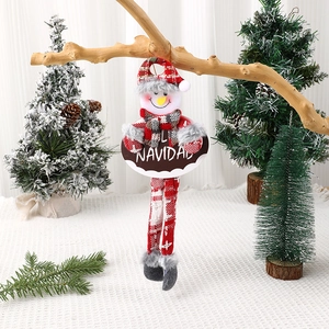 Detail view of a plush Christmas snowman hanging ornament with a red plaid hat and Navidad sign