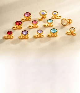 Close-up of titanium microdermal piercing jewelry with various colored zircon stones