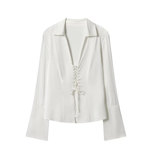 Elegant white satin blouse with deep V-neck, lace-up front, and chic flared long sleeves