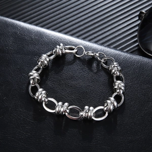 Macro view of silver industrial chain bracelet with textured threaded cylinder beads