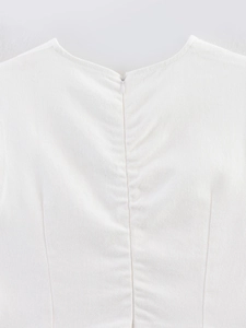 Detailed close-up of invisible zipper and twill fabric texture on a white sleeveless top