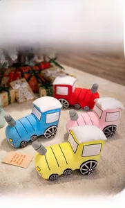 Detail showing colorful plush train toys in soft material with delicate stitching details