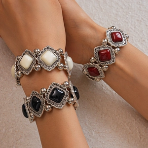 Detail of vintage geometric acrylic stretch bracelets with ornate retro silver metal frames