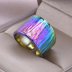 Detail of rainbow gradient ring with vertical tree bark texture and adjustable band